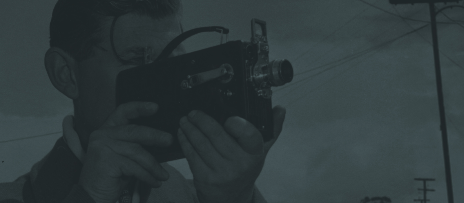 Vintage photo of a man using an old camera