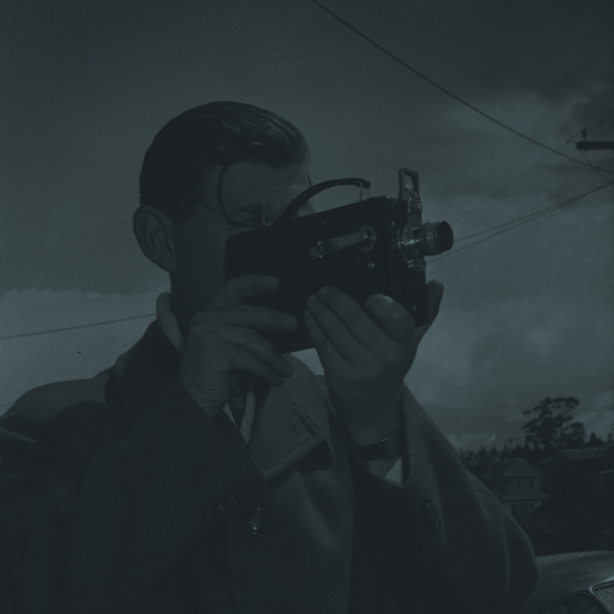 Vintage photo of a man using an old camera