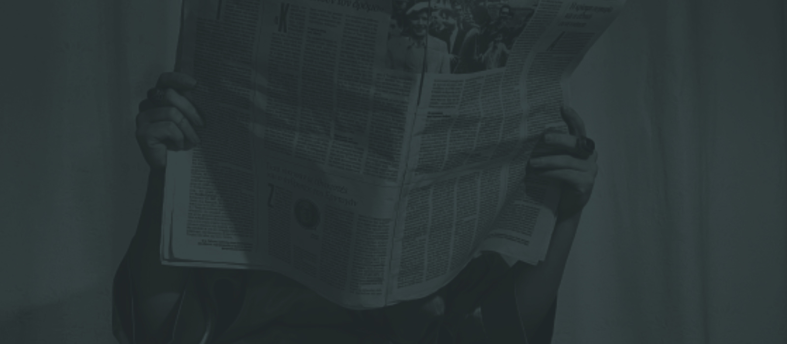 Lady reading a newspaper at breakfast