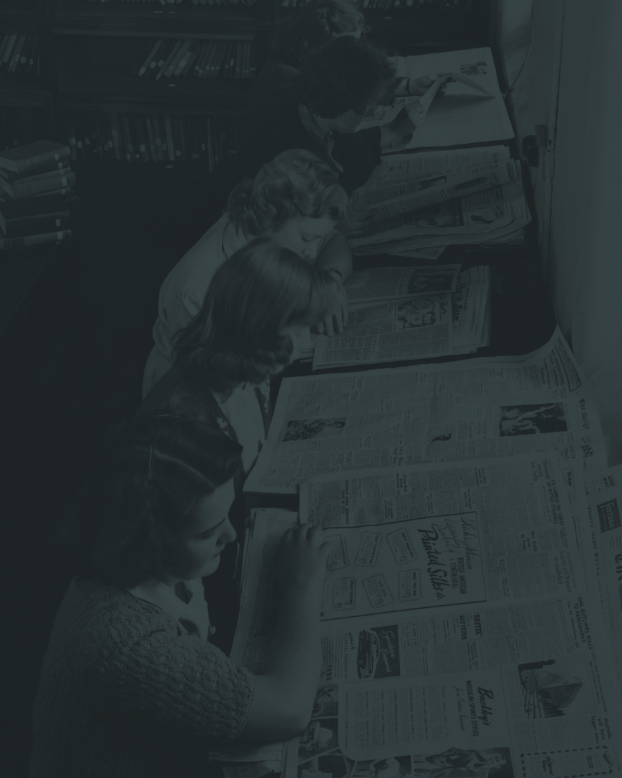 ladies reading newspapers at the library